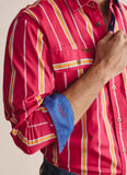 Red striped shirt with rolled-up sleeve and blue cuff, beige background